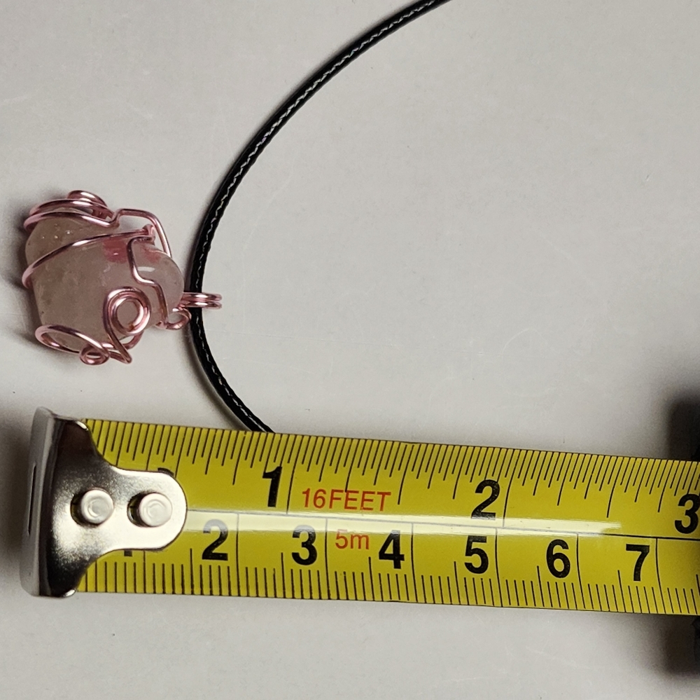 Handmade wire wrap stone pendant with cord.